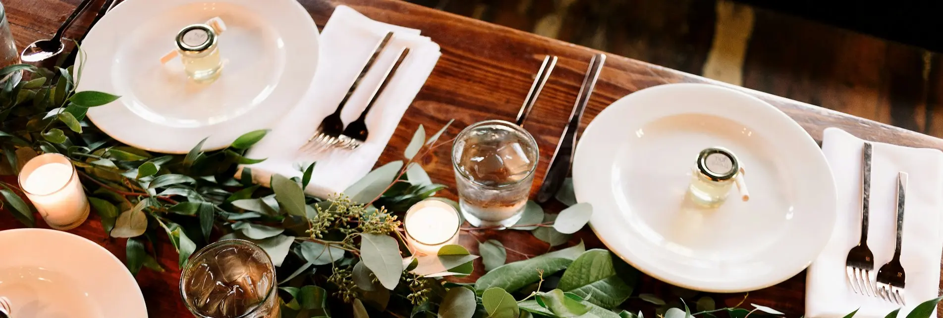 white ceramic dinner plate set on brown wooden table